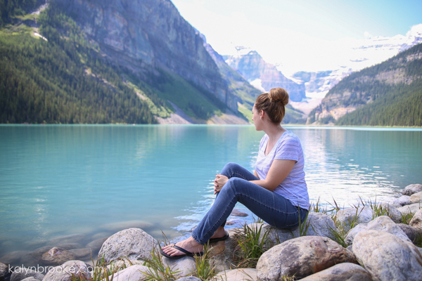 woman overlooking a peaceful lake scene